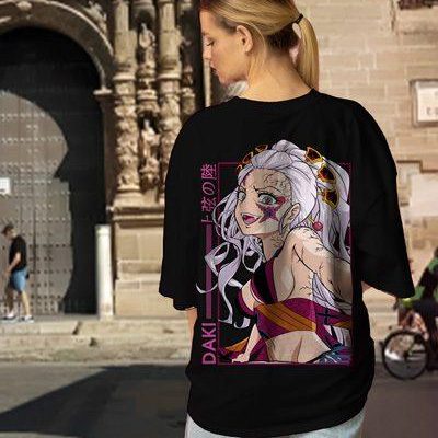 Beautiful blonde girl in a white oversized T-shirt and blue jeans posing on a gray background. High quality photo